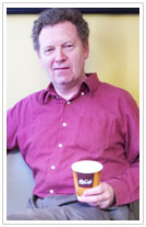 Senior Program Director Conrad MacKerron tries the new McDonald's paper coffee cup.